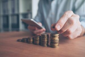 Coin stacker, businessman with stacked money